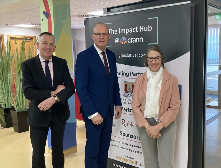 11Minister Coveney stands between Padraig Mallon and Kate Jarvey next to the accessible phone booth in the Impact Hub.